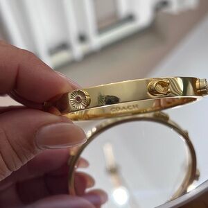 Coach Gold-Tone Floral Accent Hinged Bangle Bracelet